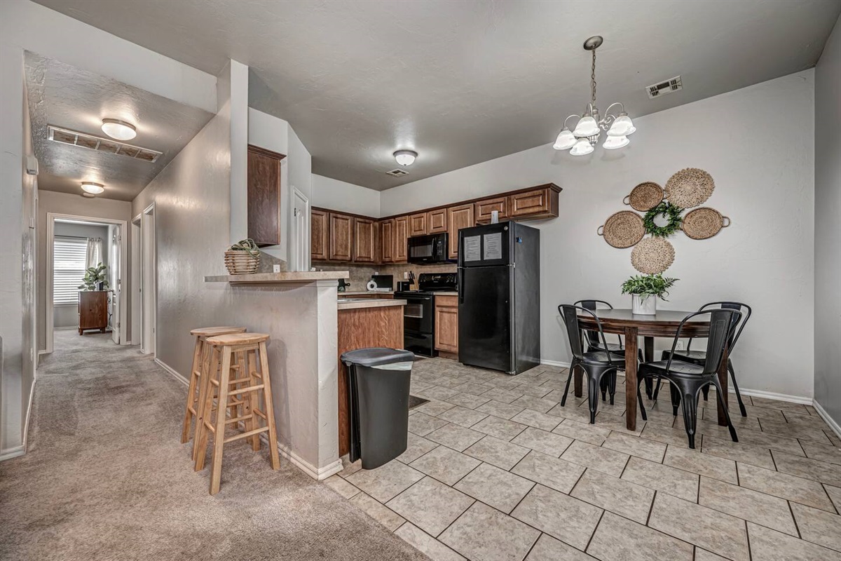 Spacious kitchen with seating for four—perfect for meals or game nights.