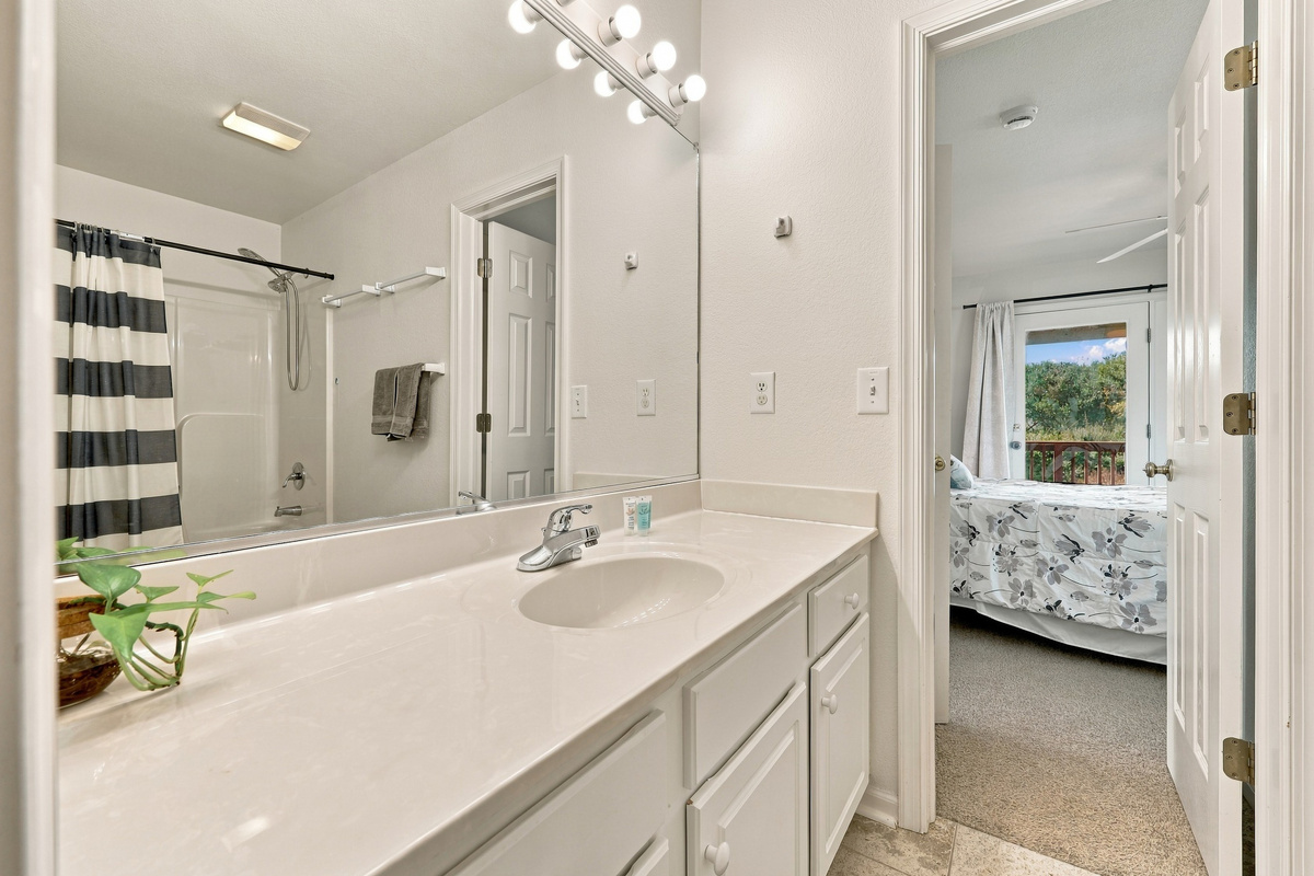 Jack-and-Jill bath with a tub/shower combo, connecting two of the bedrooms.