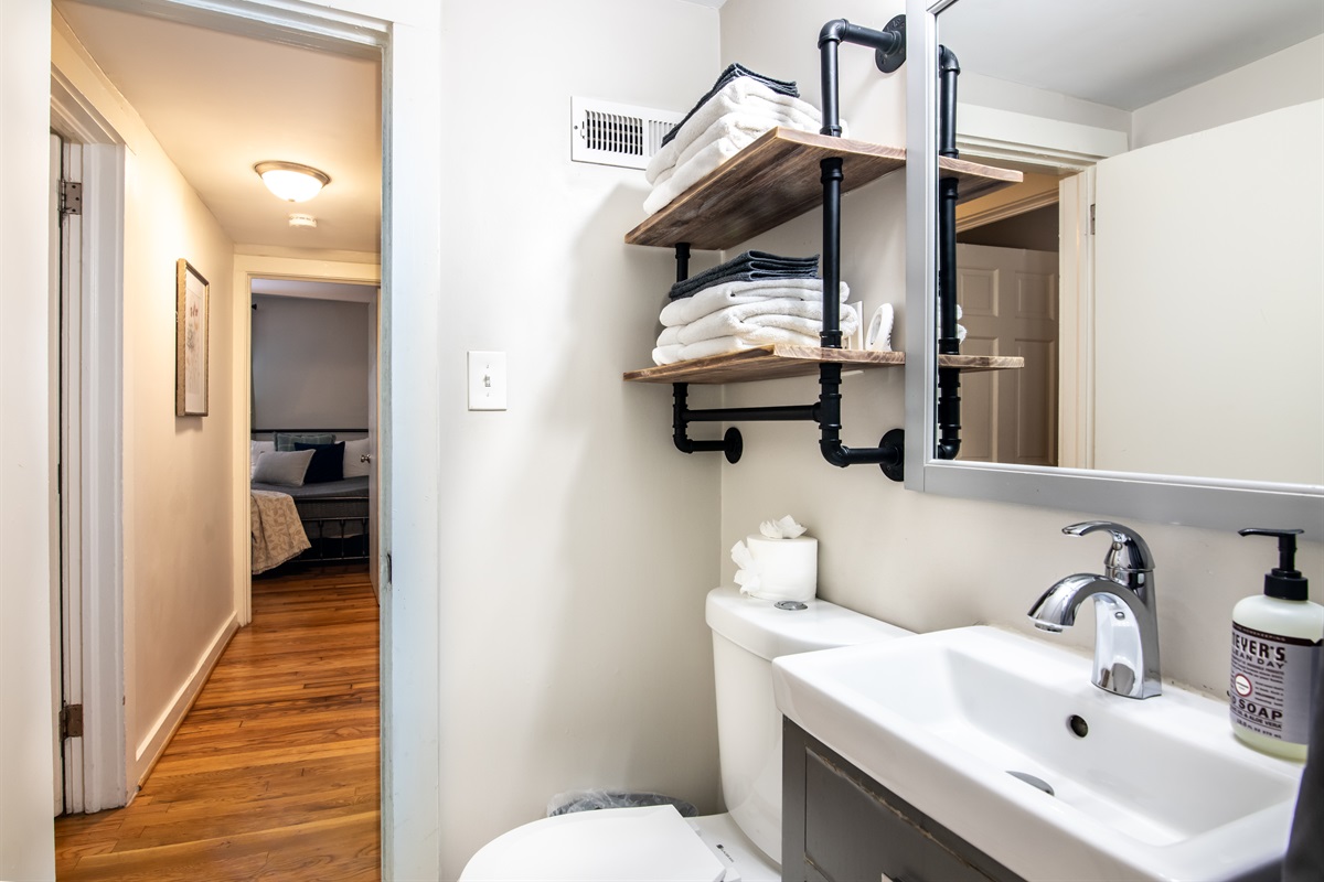 Stylish vanity and shelving area with modern industrial accents—perfect for getting ready in comfort.