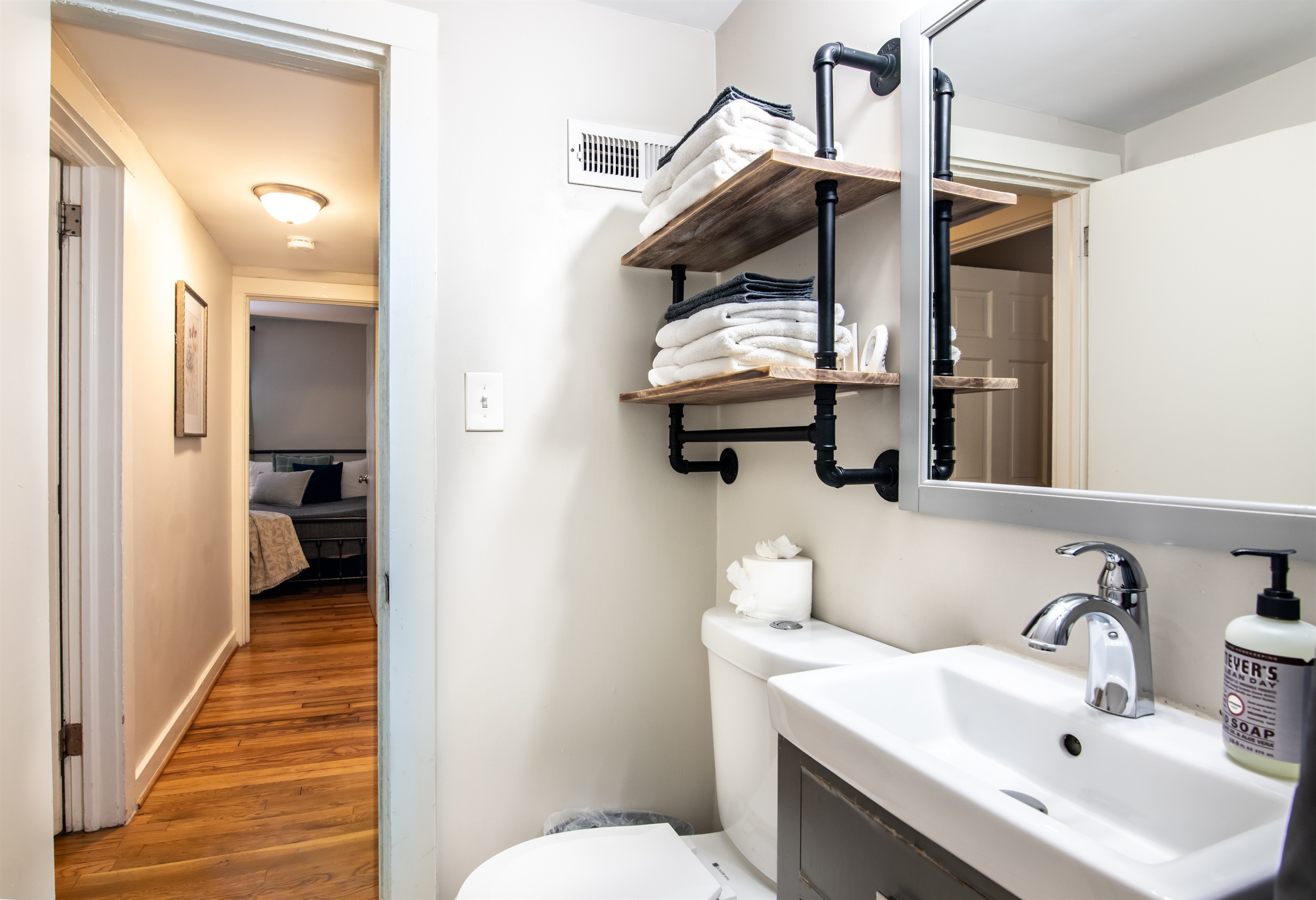 Stylish vanity and shelving area with modern industrial accents—perfect for getting ready in comfort.