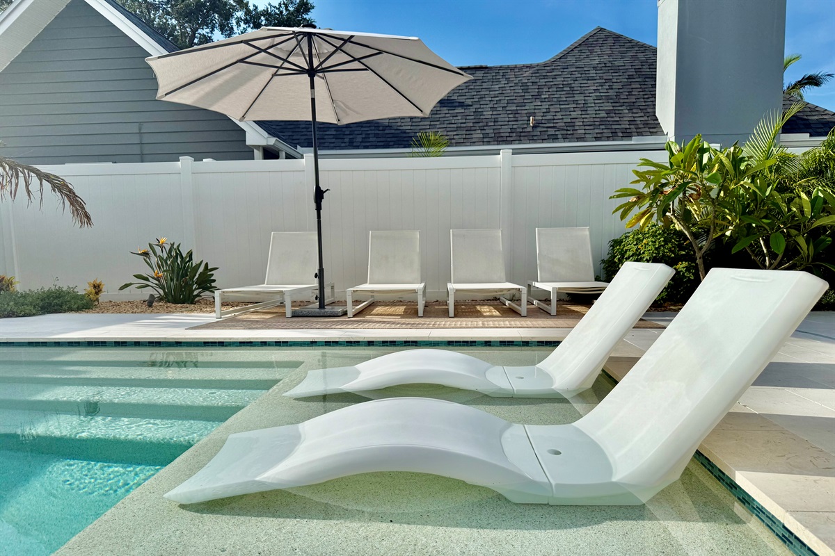 Soak up the Florida sunshine by your private heated pool—complete with in-water loungers and a stylish umbrella.