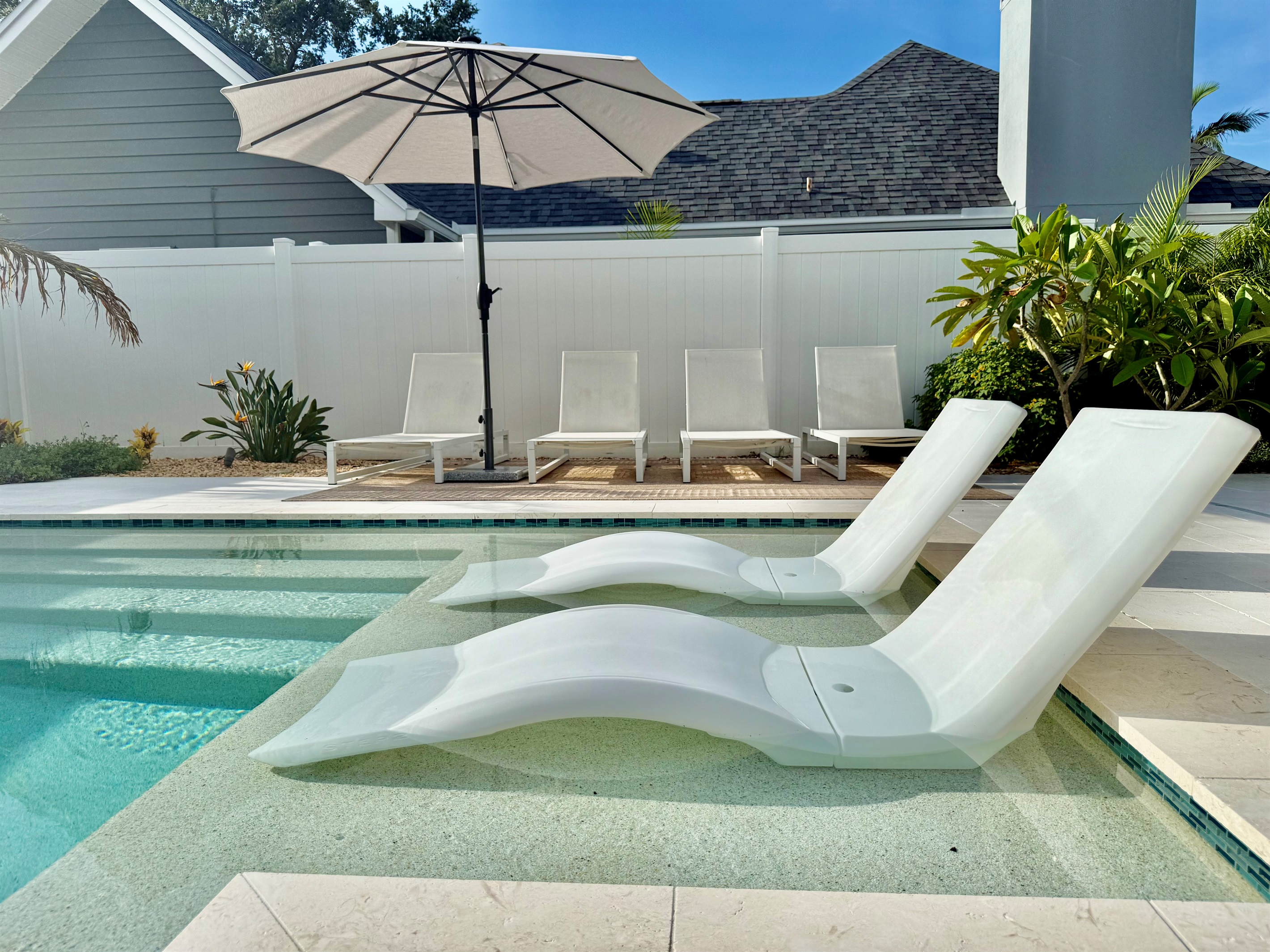 Soak up the Florida sunshine by your private heated pool—complete with in-water loungers and a stylish umbrella.