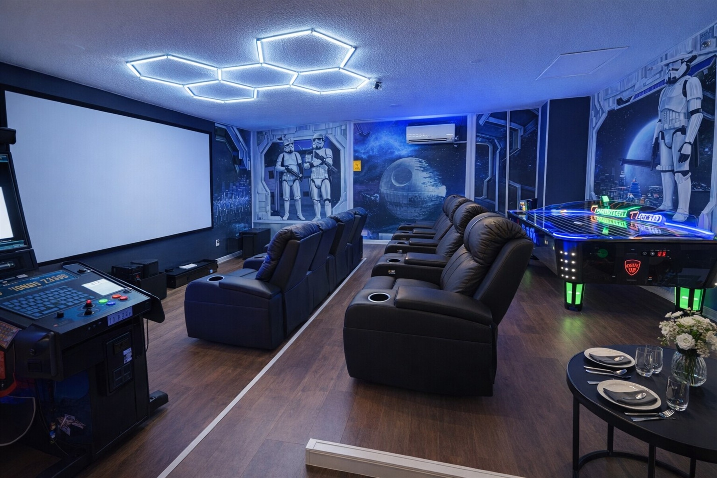 Modern home theater with reclining seats and arcade games for entertainment.