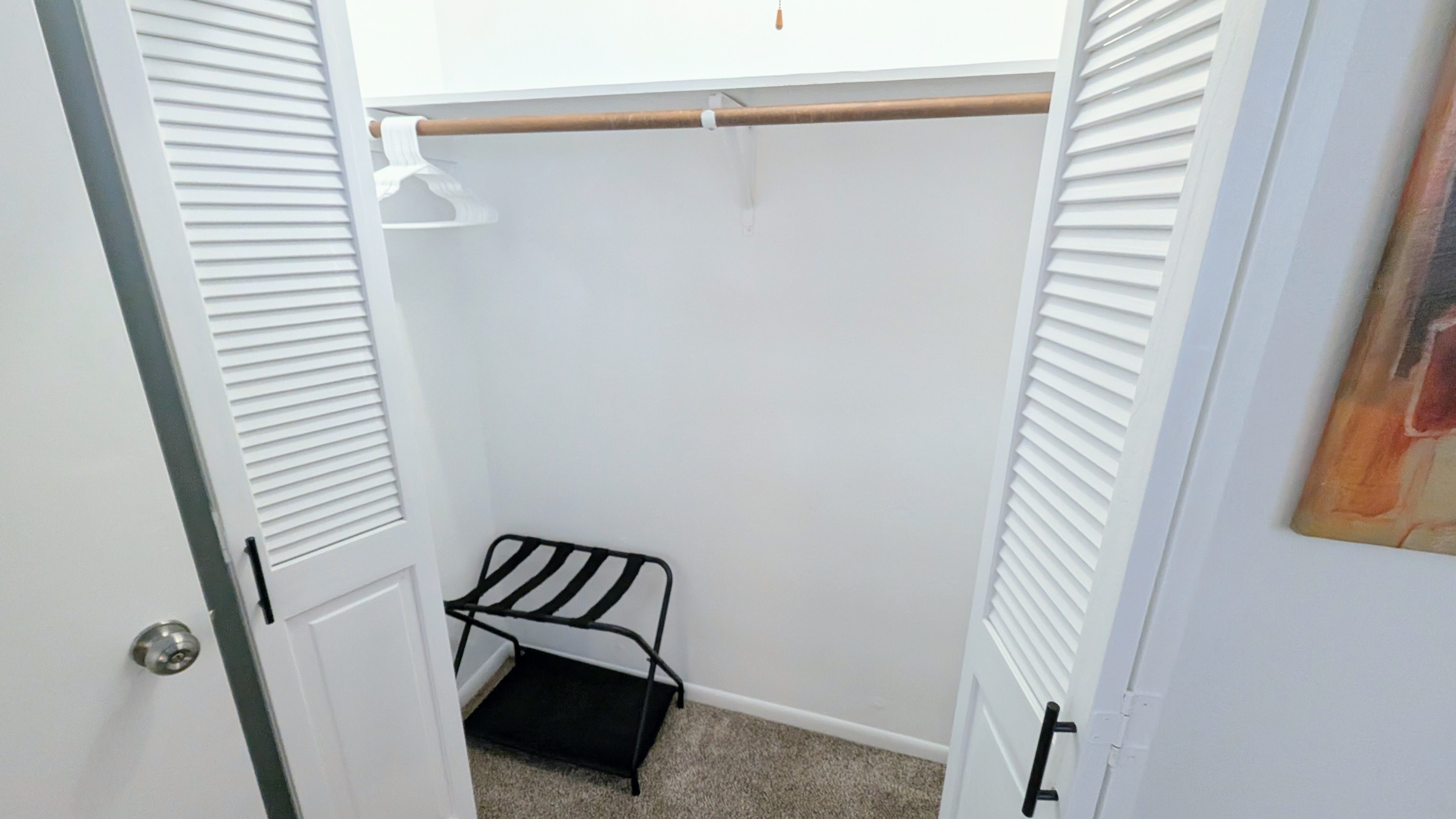 The closet is well equipped with plenty of hangers and a convenient luggage rack for your suitcase. 