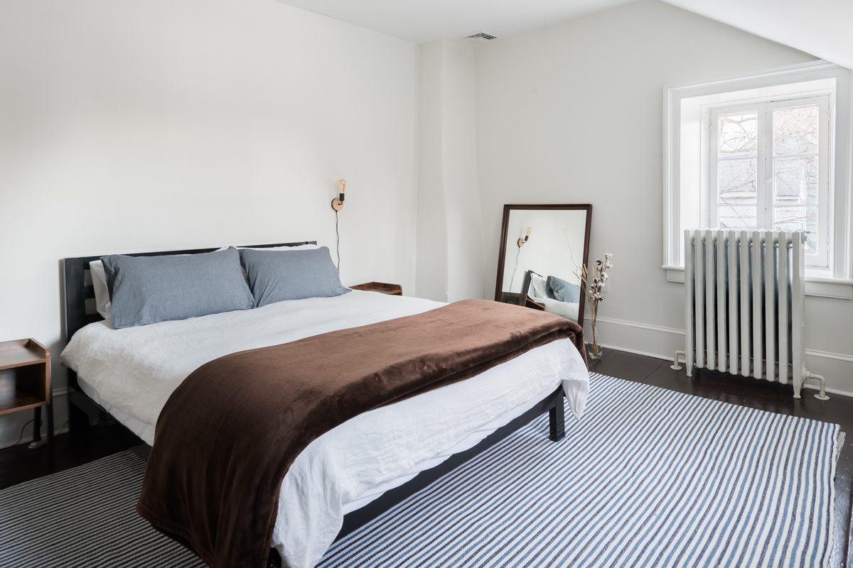 The queen bed in Bedroom 1