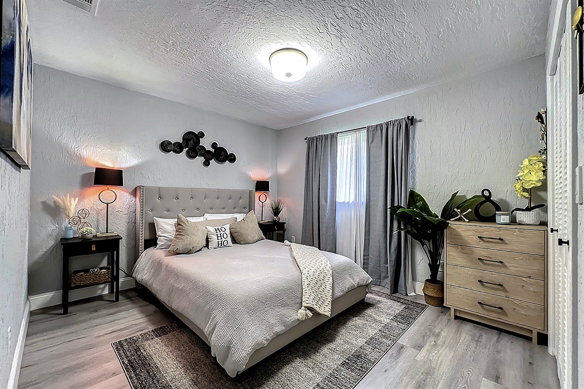 Cozy bedroom with comfortable bed, ample storage, and natural light for a restful guest experience