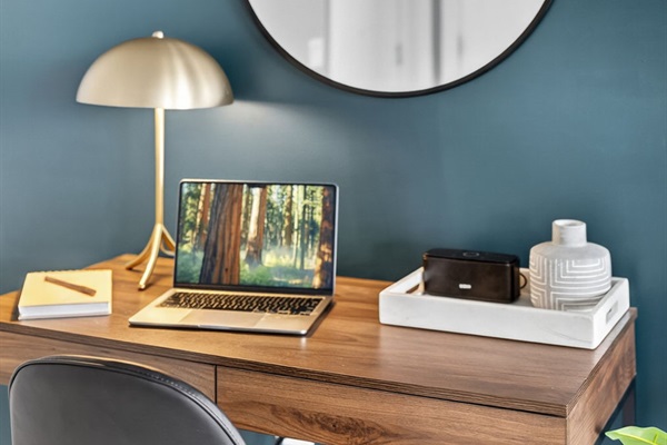 Clean and modern workstation with soft seating, minimalist decor, and a welcoming vibe for work or journaling.