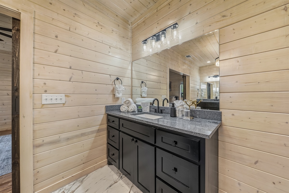 A clean, airy vanity with gentle lighting and a peaceful peek into the trees, perfect for getting ready at your own pace.