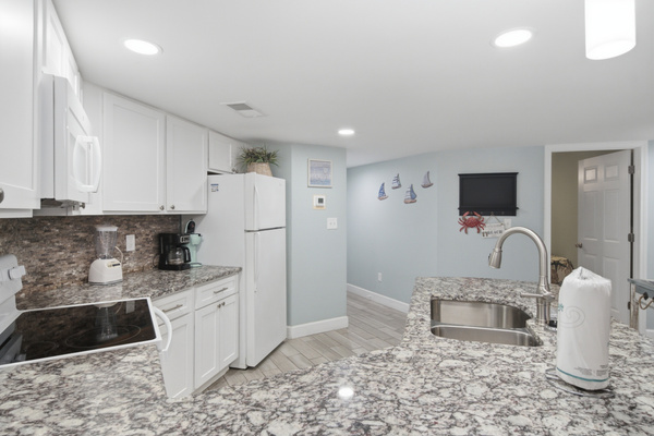 Coffee station and in-unit washer/dryer tucked just off the kitchen