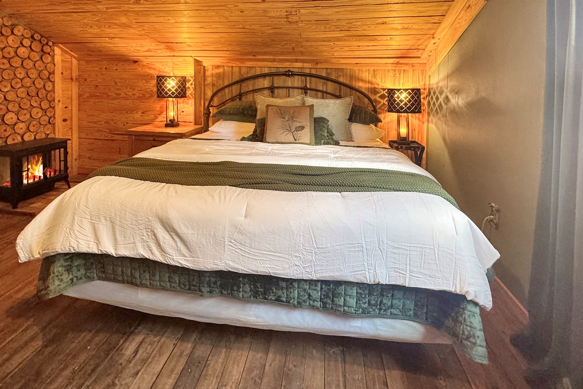 Fireplace ambiance meets plush comfort. Bedside lamps with USB ports included!