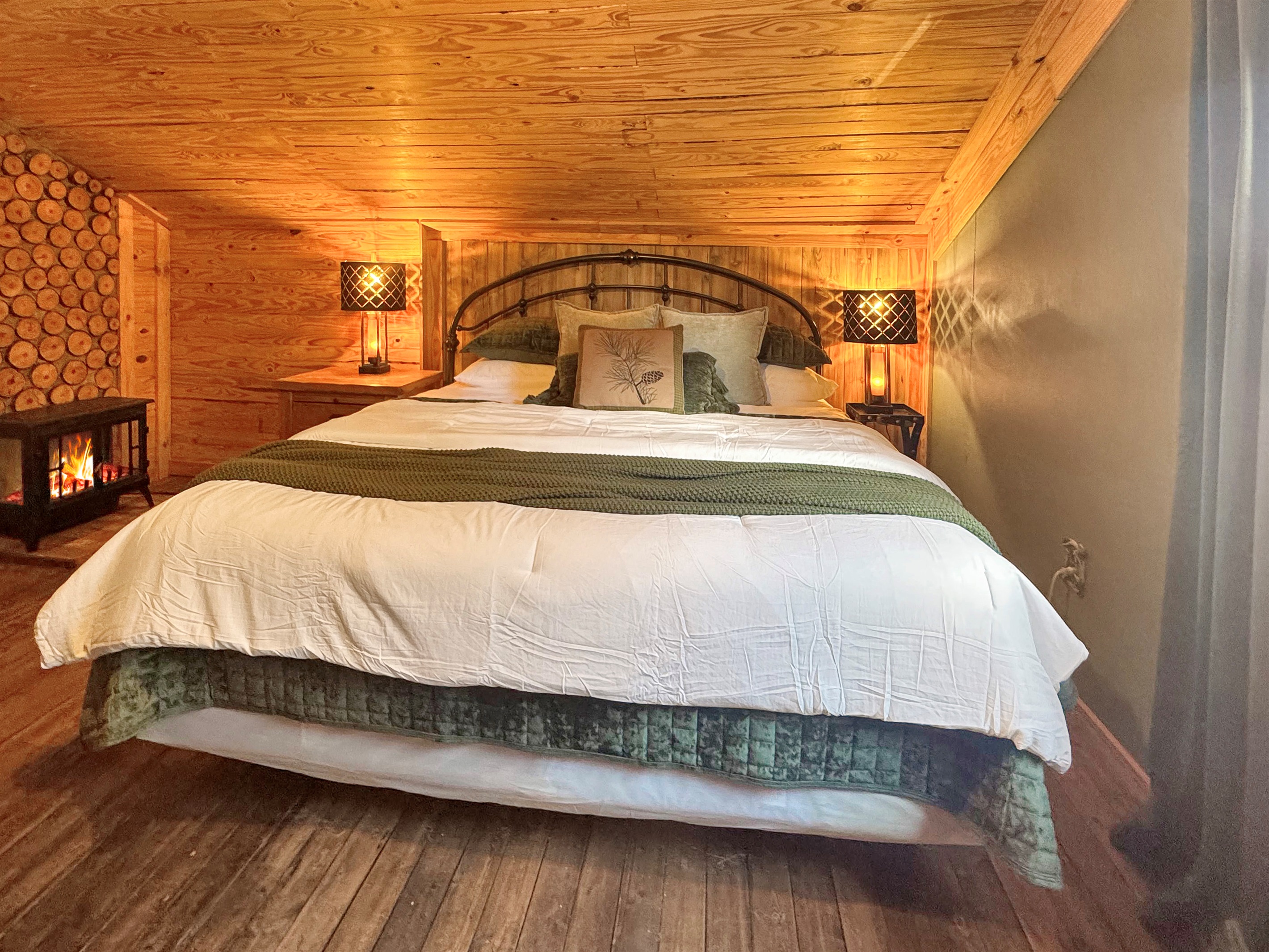 Fireplace ambiance meets plush comfort. Bedside lamps with USB ports included!