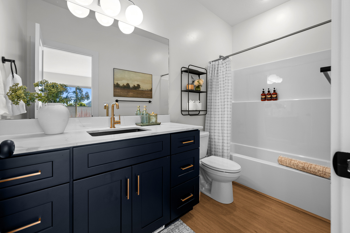 A full bathroom with dual sinks provides extra convenience for families and groups.
