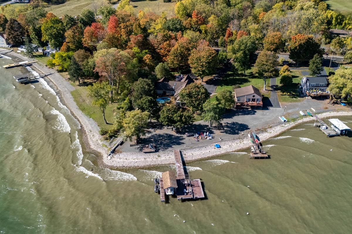 Lakefront escape nestled in fall colors with a private shoreline perfect for morning coffee views. Ideal for guests seeking peaceful Finger Lakes relaxation.