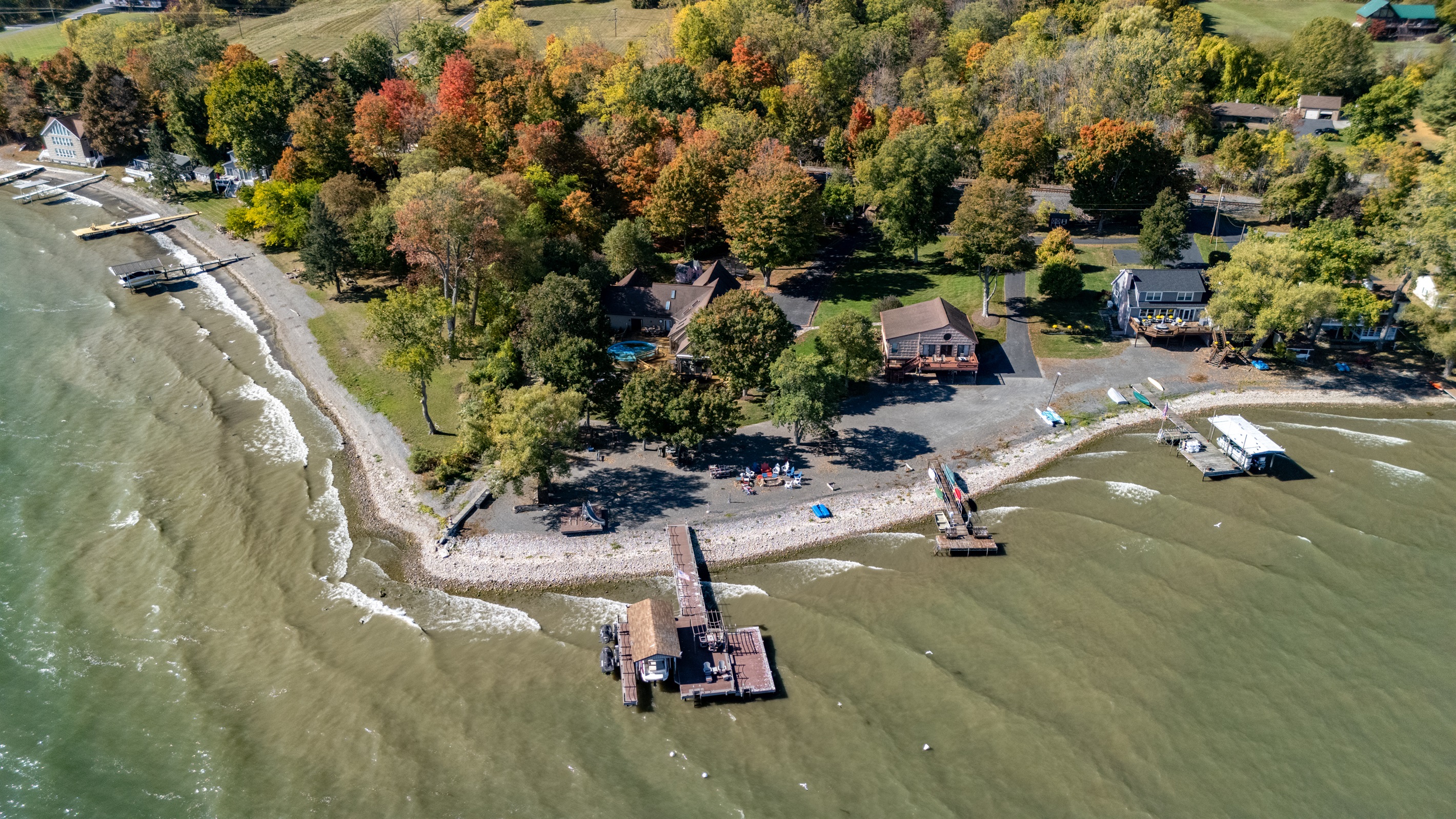 Lakefront escape nestled in fall colors with a private shoreline perfect for morning coffee views. Ideal for guests seeking peaceful Finger Lakes relaxation.