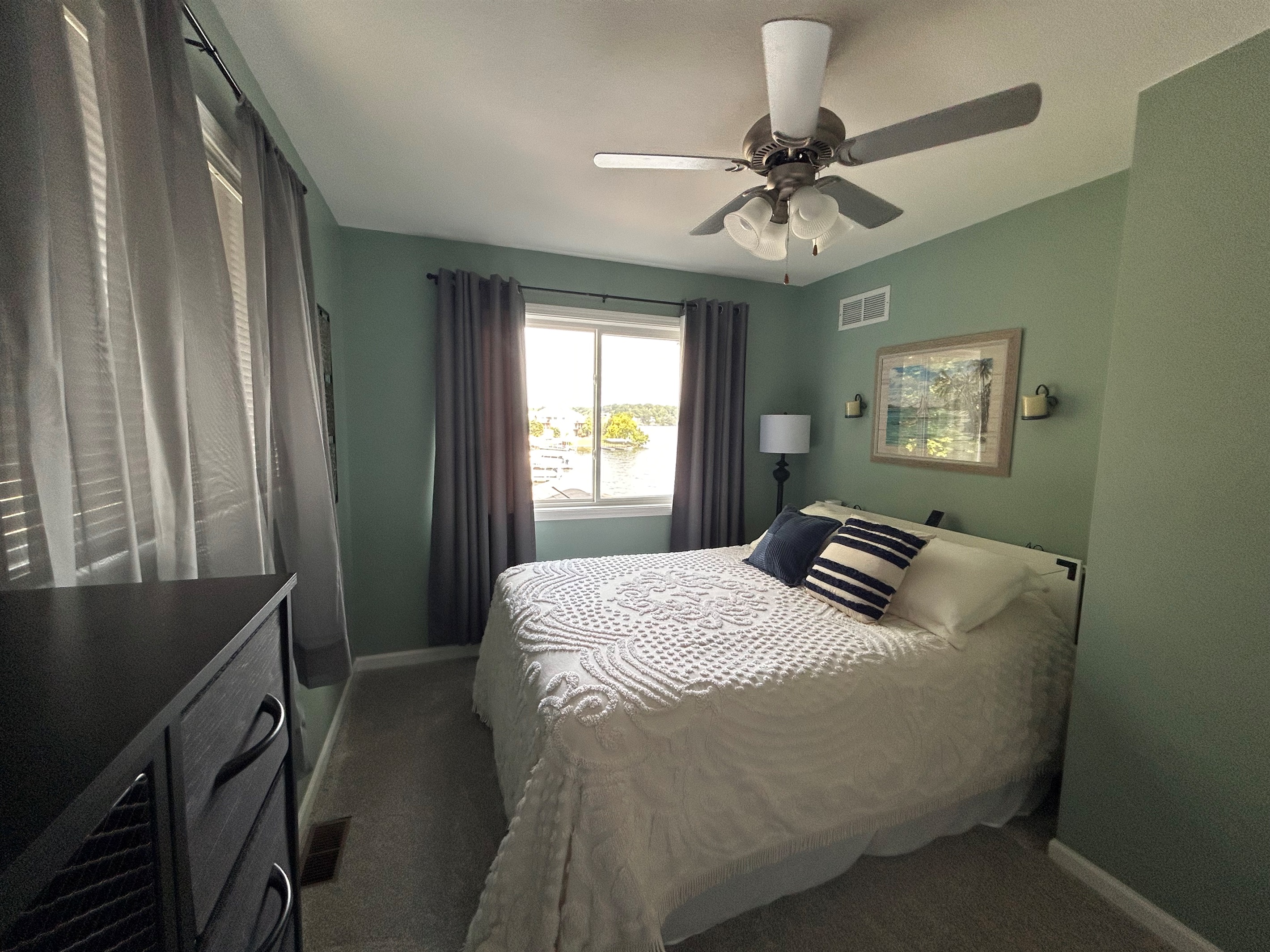 Bedroom with queen bed and beautiful view of lake