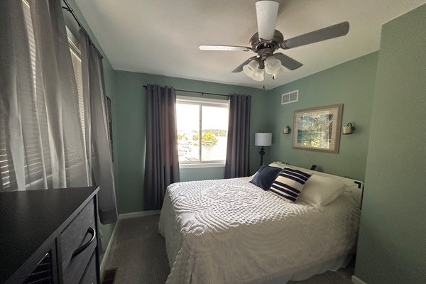 Bedroom with queen bed and beautiful view of lake