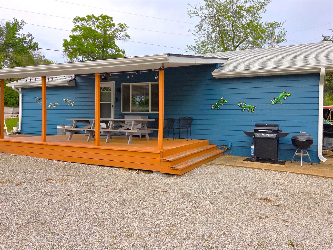 The large front deck is a perfect hangout for anytime of the day with a ceiling fan, plenty of seating, and views overlooking Table Rock Lake!