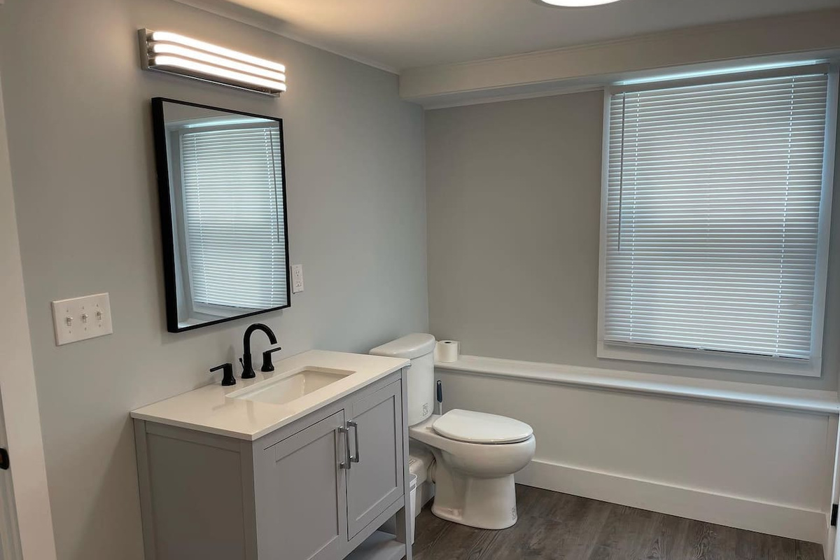 The lower level half bath with washer and dryer. 