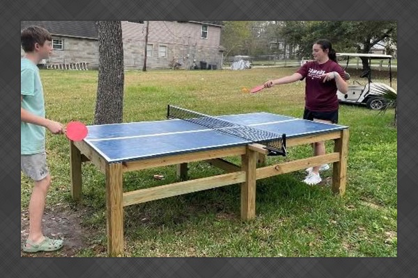 Cousins enjoying a cut-throat game of ping pong!