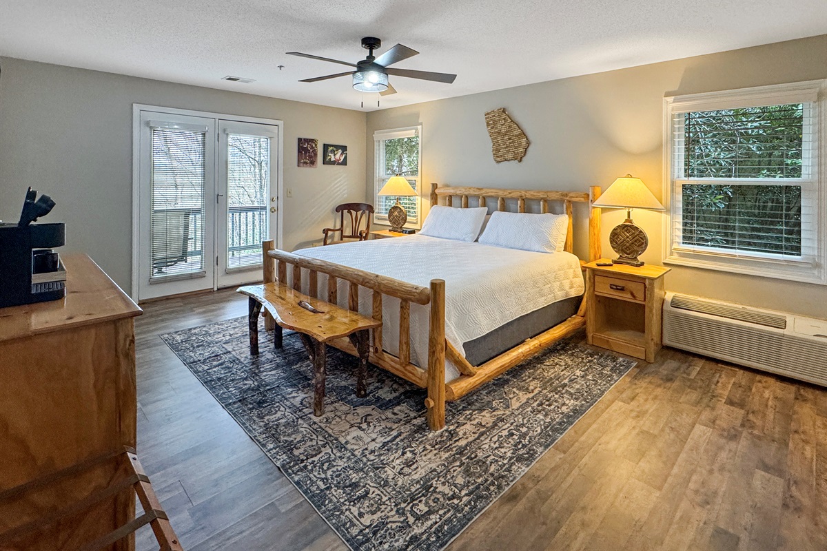 Natural light fills the room, with easy access to the deck for fresh air and peaceful mornings surrounded by trees.