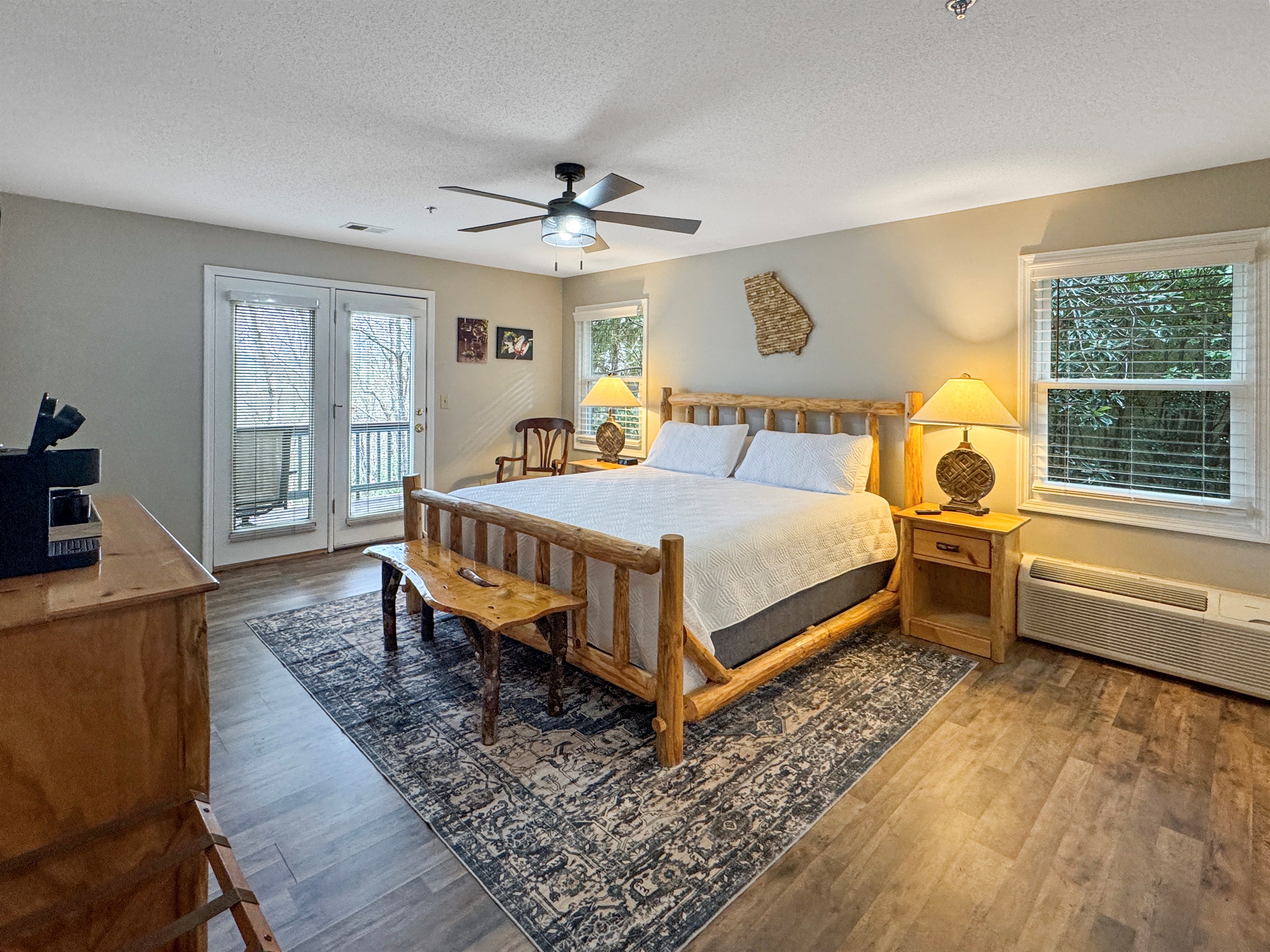 Natural light fills the room, with easy access to the deck for fresh air and peaceful mornings surrounded by trees.