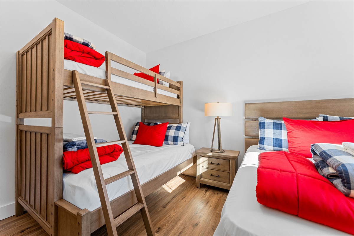 Spacious bunk room on the main level with twin over full and another full bed, perfect for families or kids.
