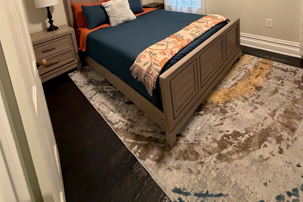 stylish bedroom with queen bed with a calming color palette