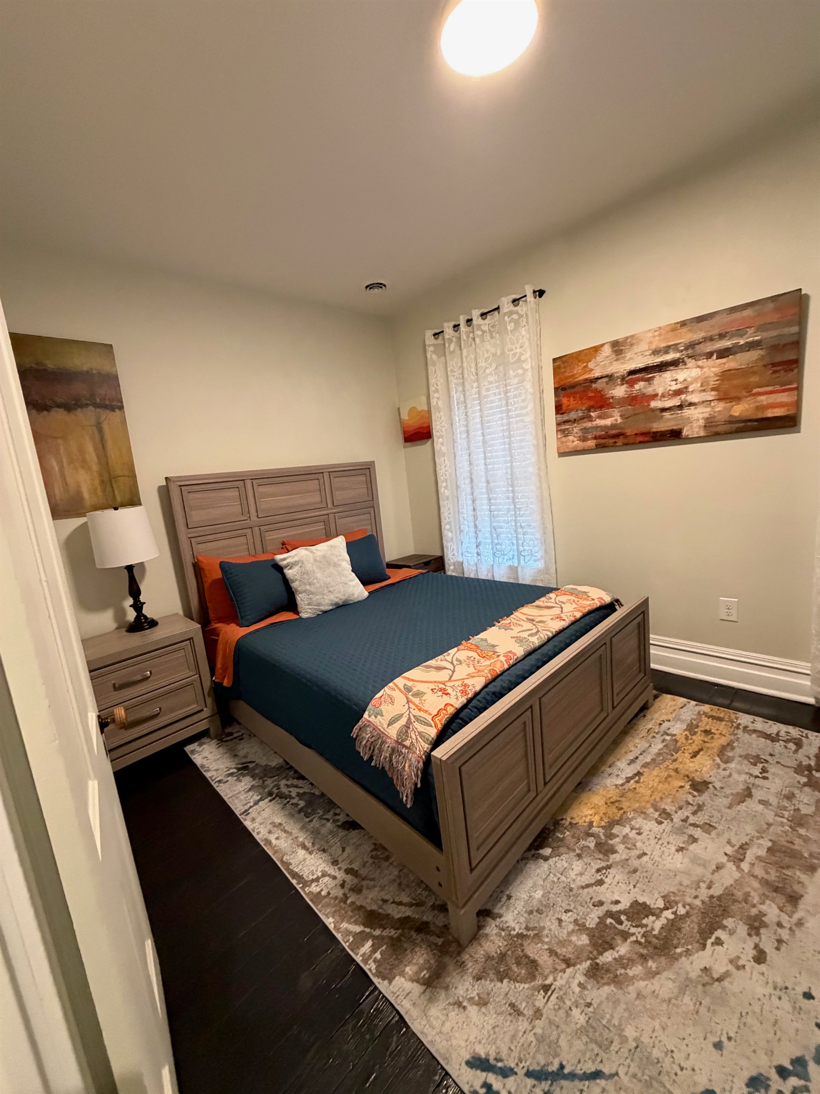 stylish bedroom with queen bed with a calming color palette