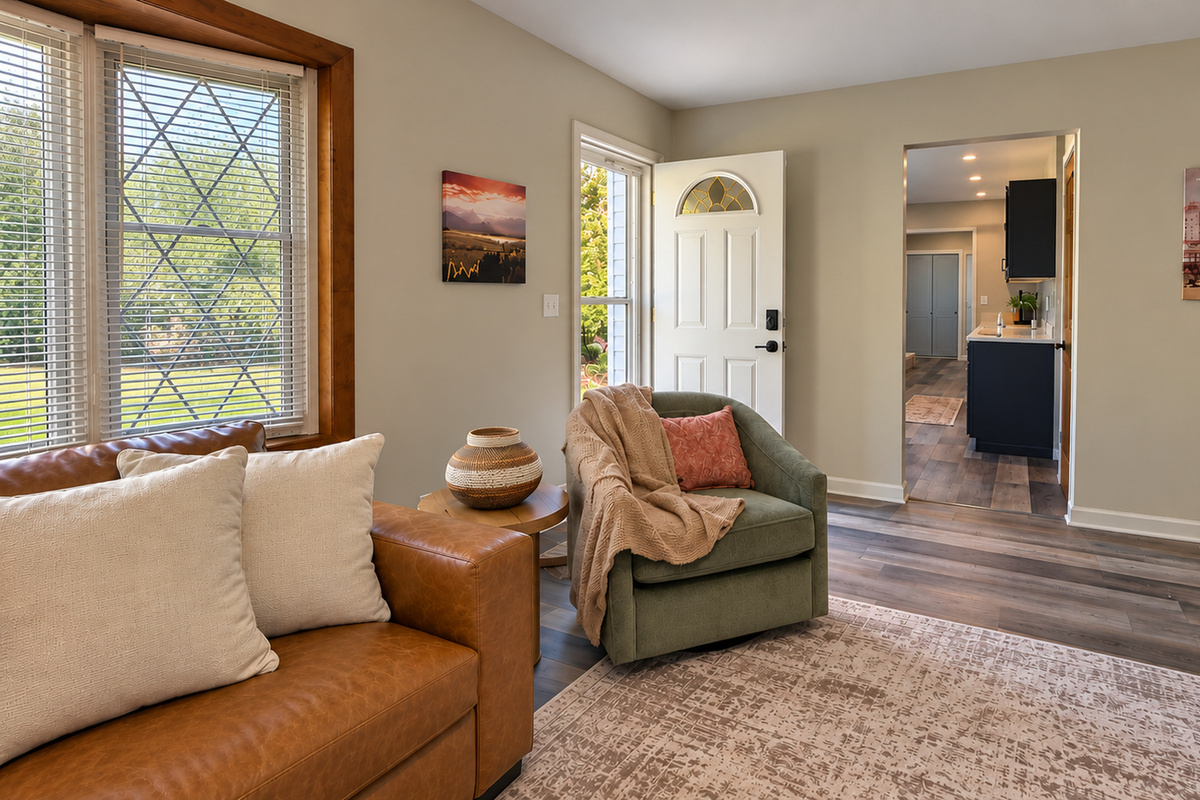 A welcoming entry opens into a spacious living room with comfortable seating, warm finishes, and easy access to the fully updated kitchen.