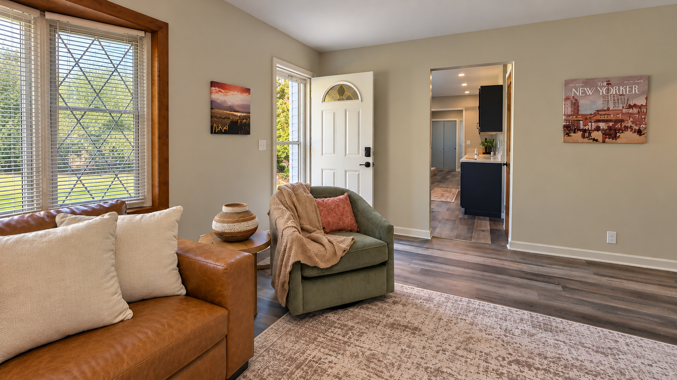 A welcoming entry opens into a spacious living room with comfortable seating, warm finishes, and easy access to the fully updated kitchen.