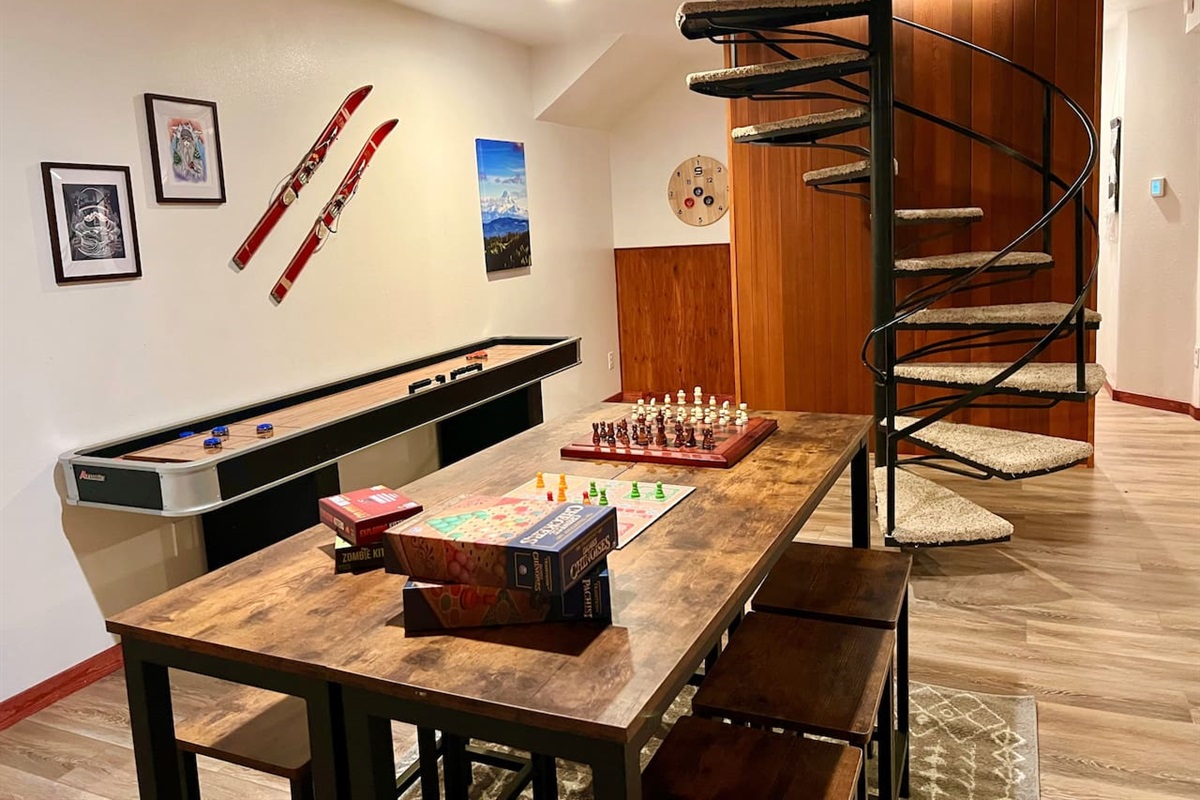 Mount Hood and Winter Sports Themed Game Room with Wood Burning Fireplace and Large Smart TV.