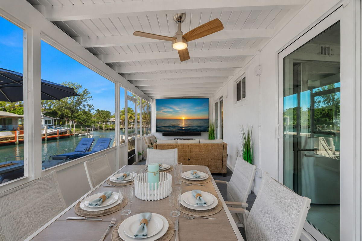 Waterfront dining with seating for six, plus a built-in extension leaf to accommodate up to 10 guests, canal views, and a 65” TV.
