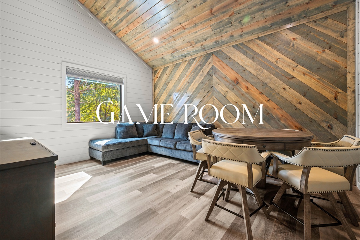 The game room is a lively space for movie nights, family fun, or friendly competition.