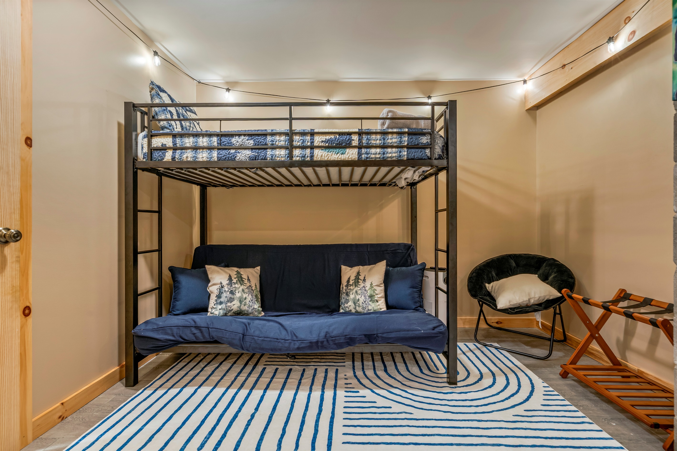 The adjoining room features a cozy twin loft bed and a trundle