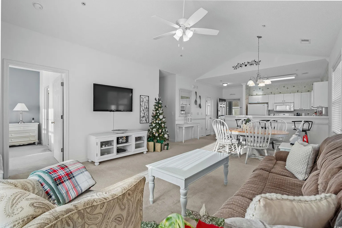 Cozy living room with large TV, sofa bed and balcony access