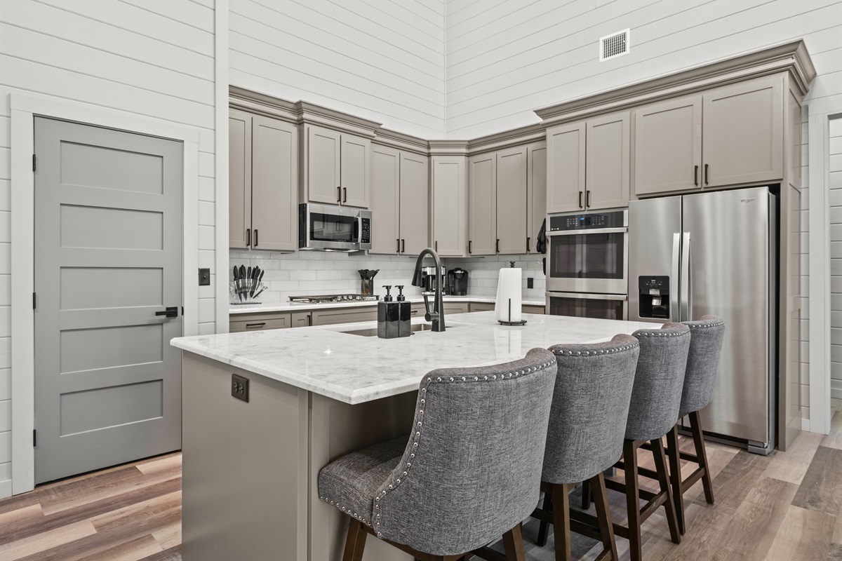 With modern appliances and bar seating for guests, this kitchen makes mealtime feel like part of the fun.