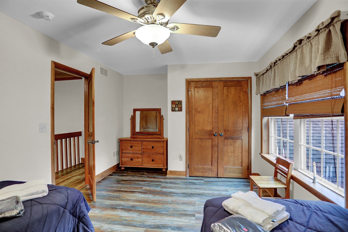 Upstairs bedroom 2 singles with dresser and closet