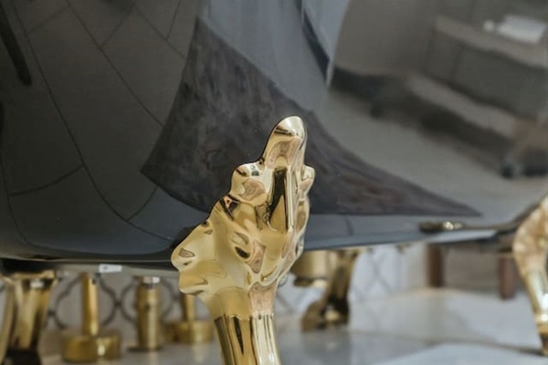 Elegant gold clawfoot detailing adds a touch of classic luxury and timeless charm to the space
