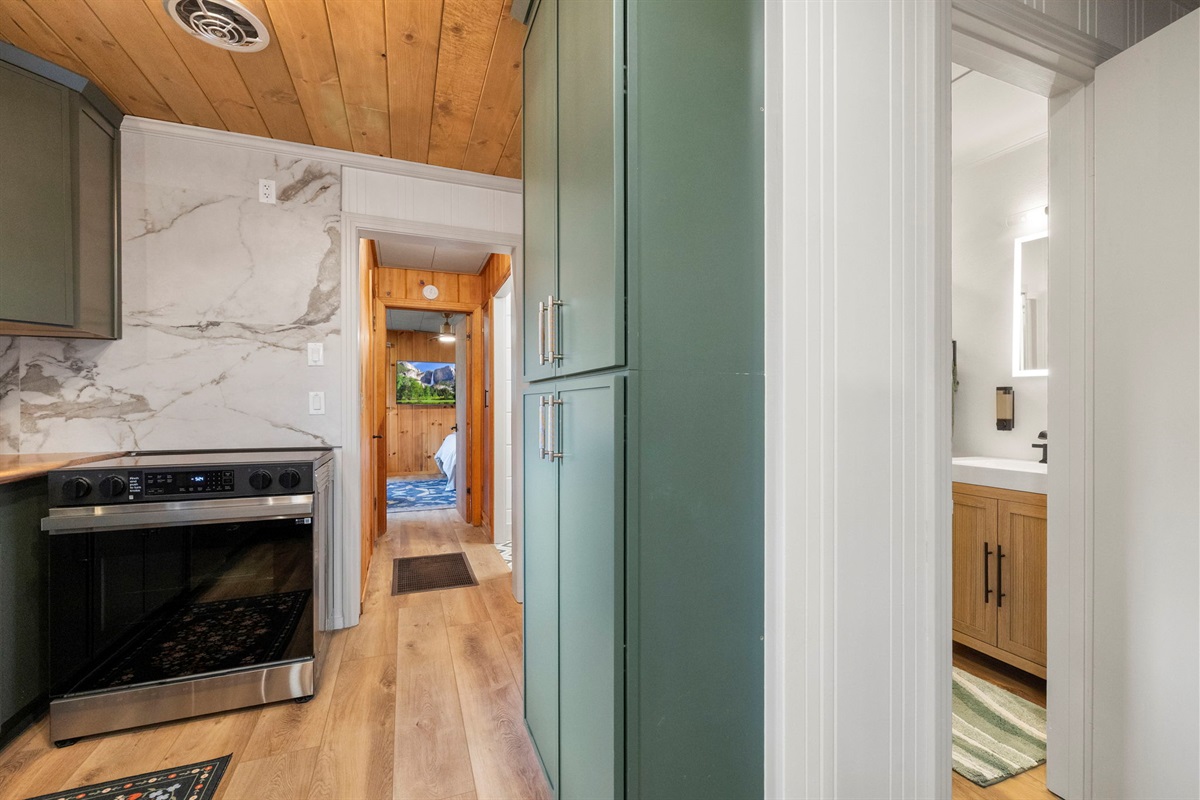 Small hallway off kitchen to the right leads to master bedroom and bathroom. The other hallway leads to the hall bath, mud room and backyard exit and the bunk room.