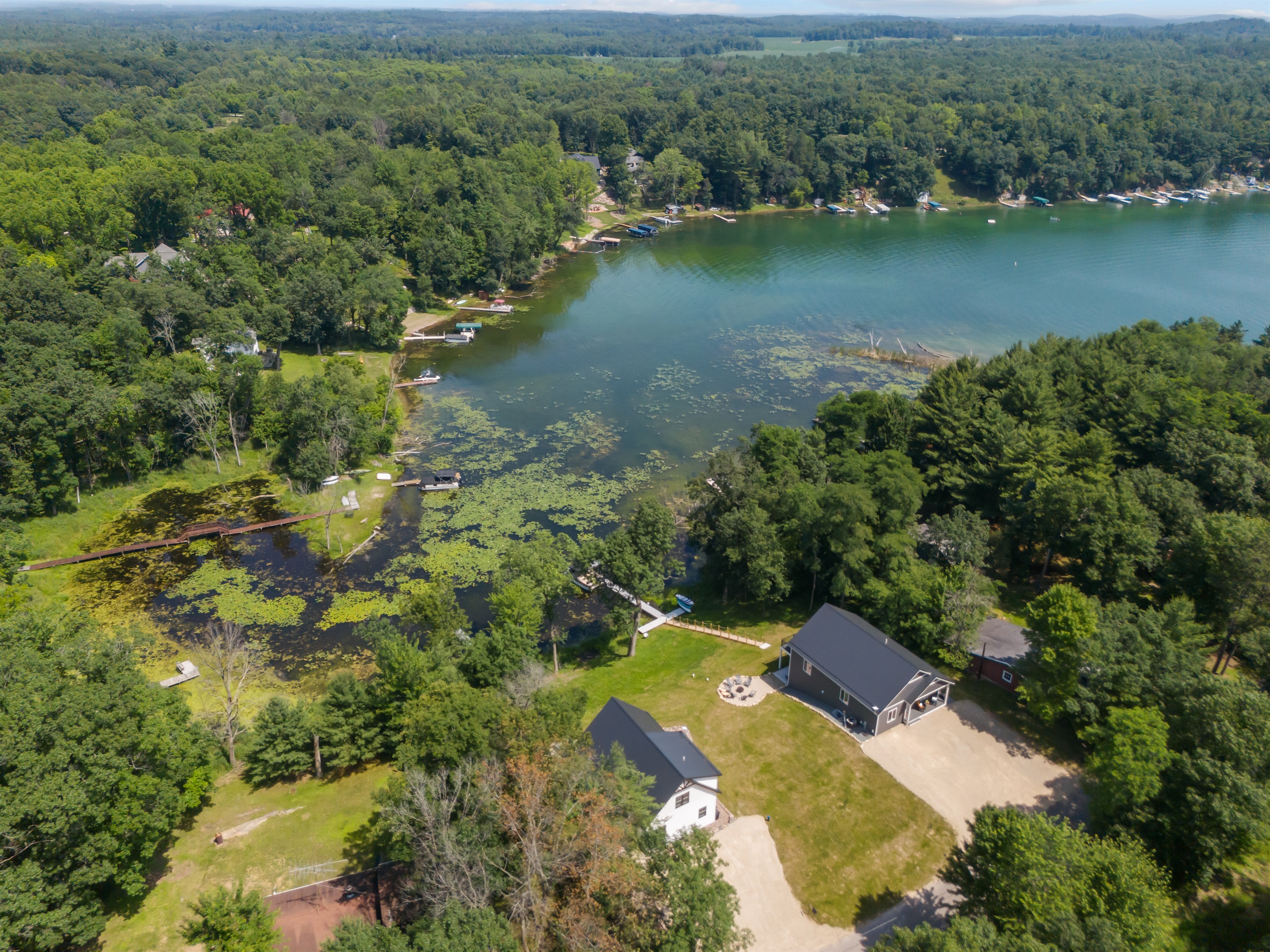 A bird’s-eye view of the property—this drone shot captures the full layout, including the house, yard, and surrounding scenery.