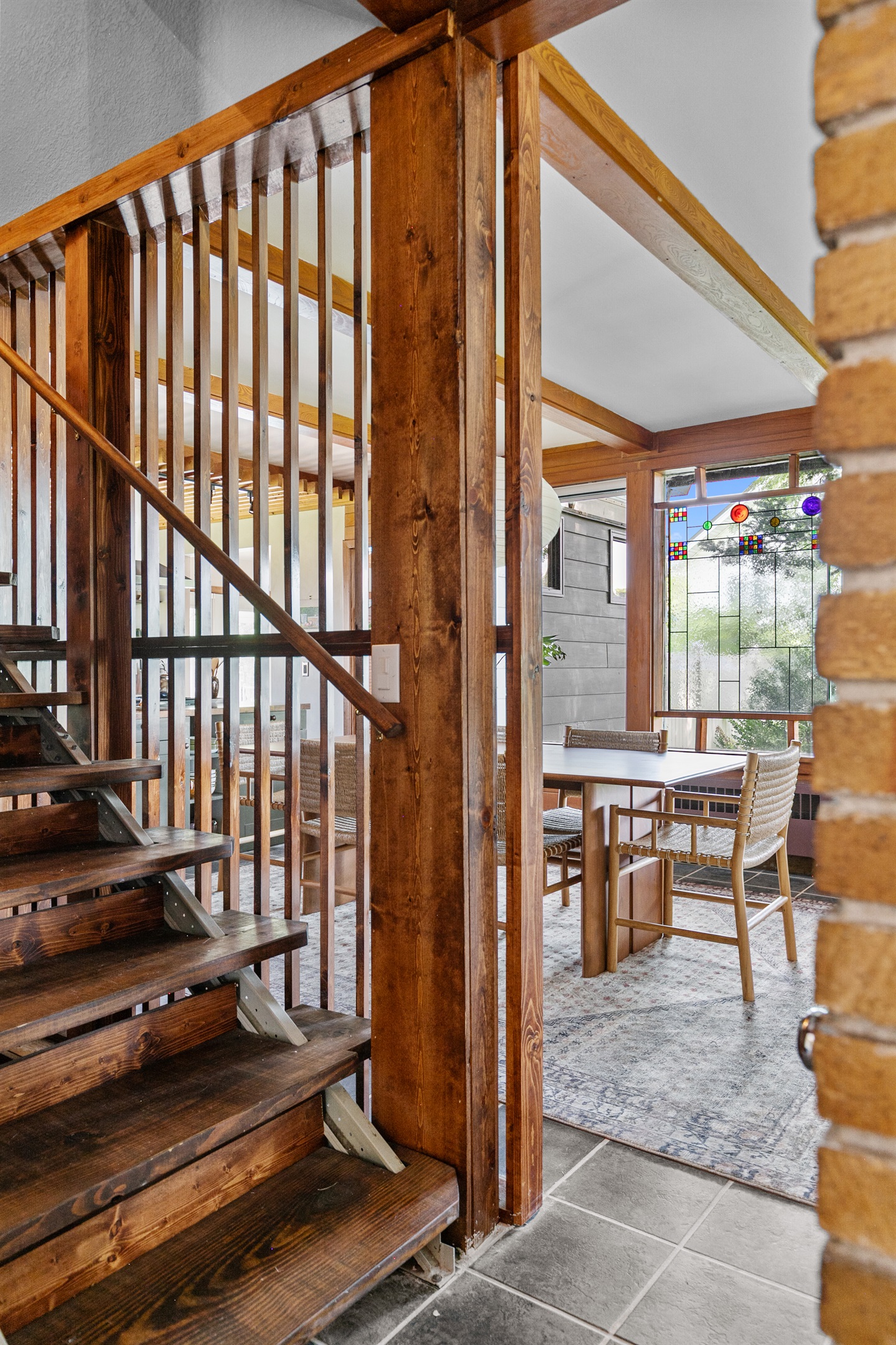 Open, slatted-wood stairs showcase the home’s sleek modern design.