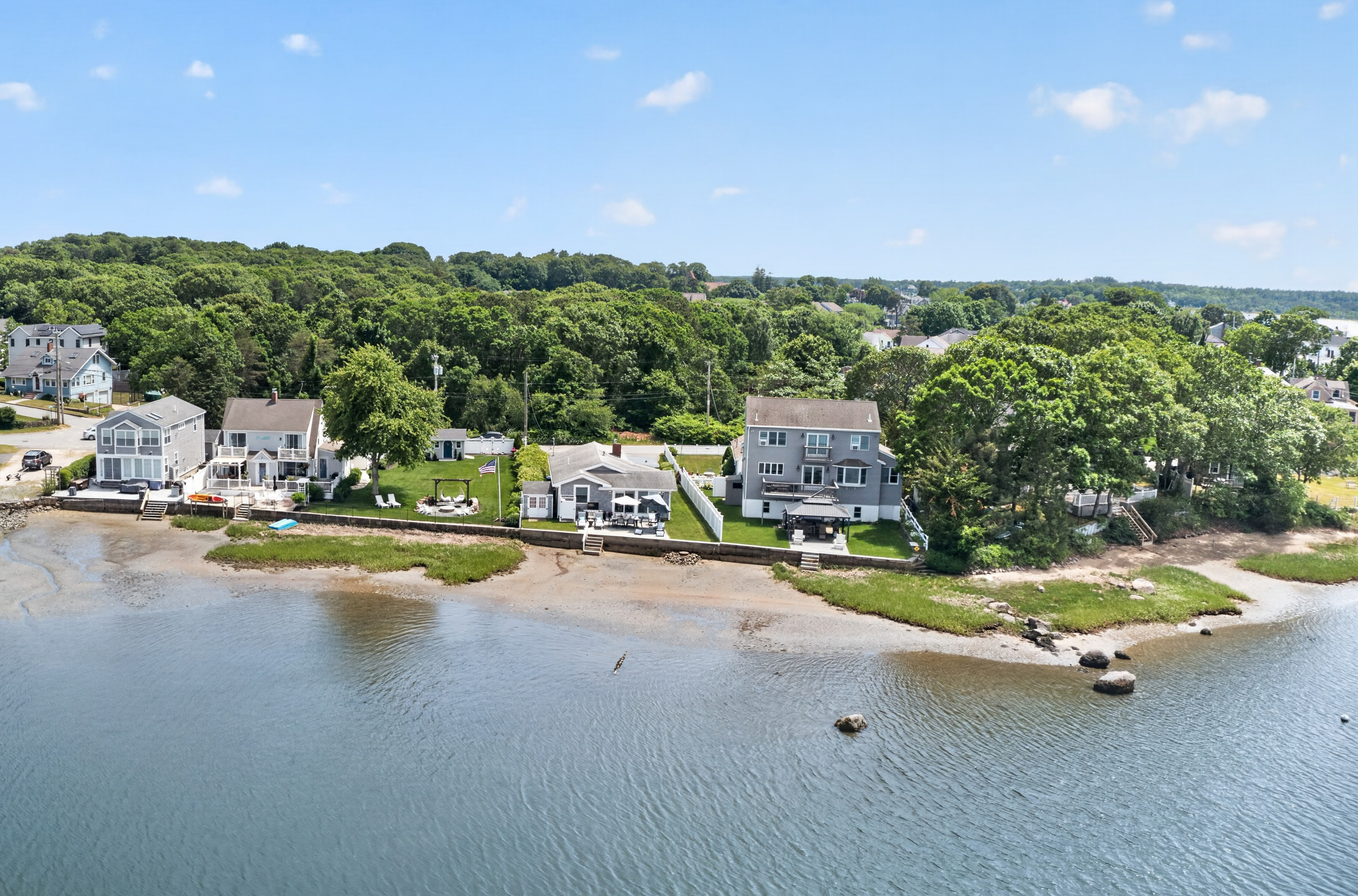 Bird's-eye view highlighting the home's picturesque waterfront location within the neighborhood.
