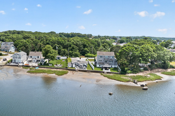 Bird's-eye view highlighting the home's picturesque waterfront location within the neighborhood.