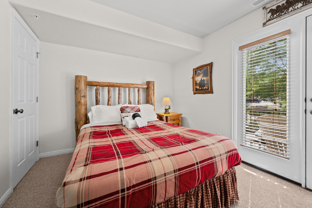The second bedroom is outfitted with a queen bed, luxurious linens, and plush pillows.