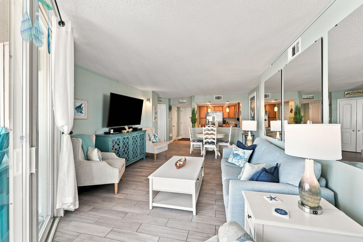 Unwind after a day at the beach in this comfortable living space with generous seating and beachy decor.
