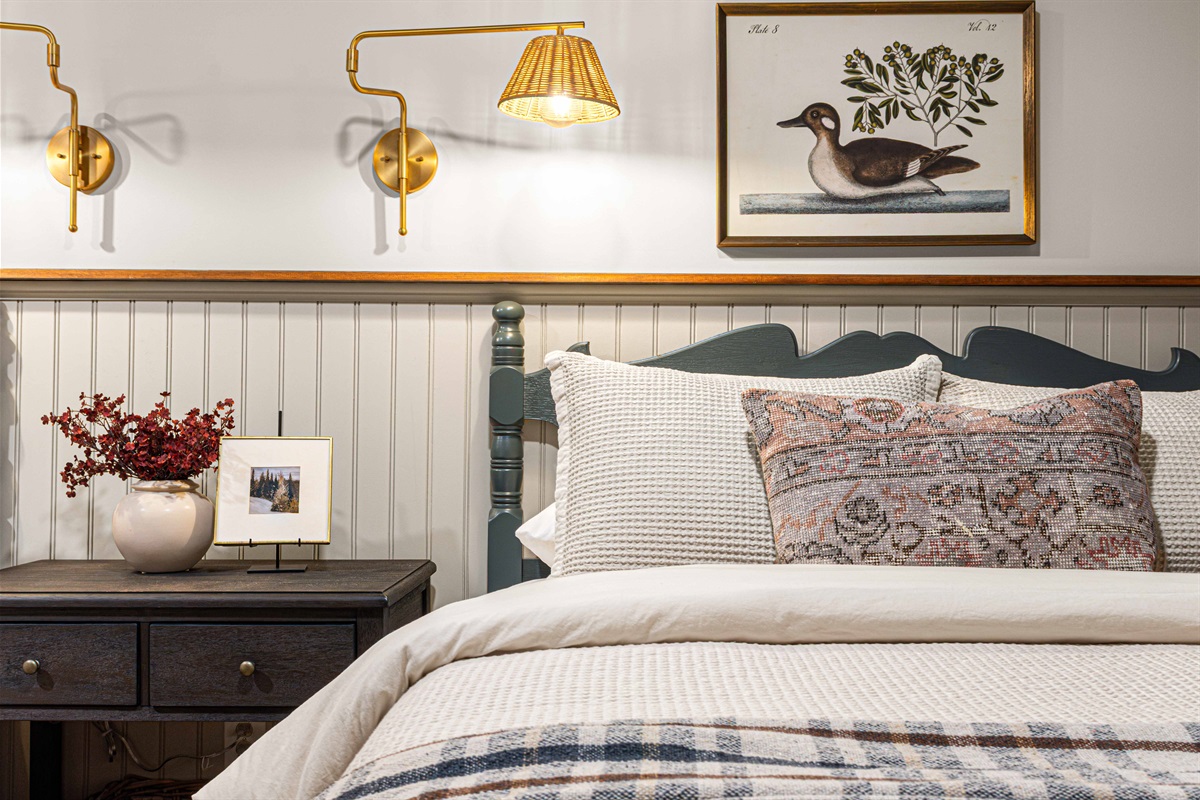 A close-up view highlights layered bedding, soft lighting, and thoughtful details that make the Duck Room feel polished and inviting.
