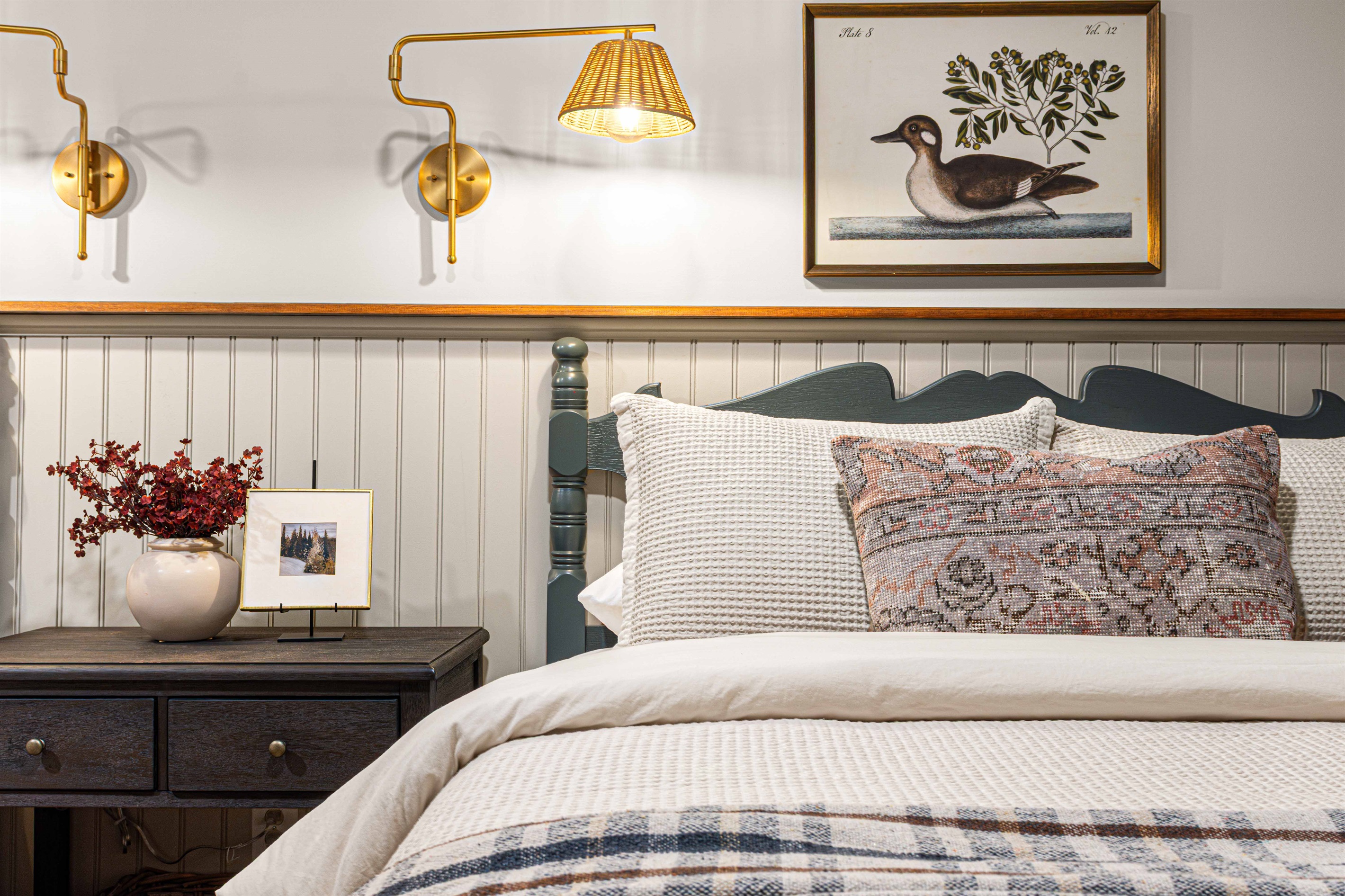 A close-up view highlights layered bedding, soft lighting, and thoughtful details that make the Duck Room feel polished and inviting.