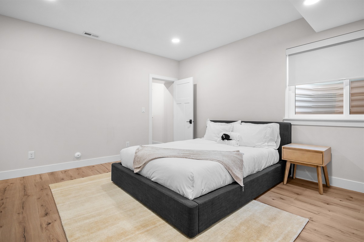 Bright and airy lower-level Queen Bedroom designed for restful nights.