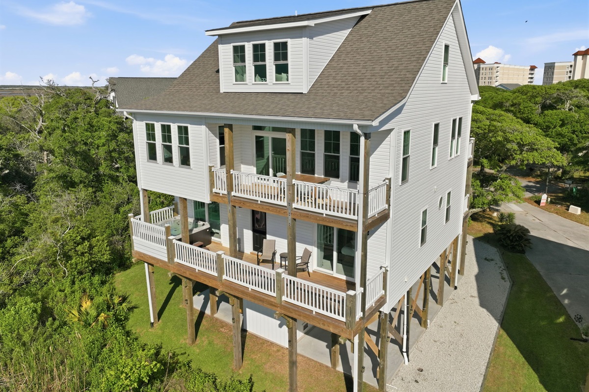Elevated coastal home with spacious outdoor living and a private hot tub