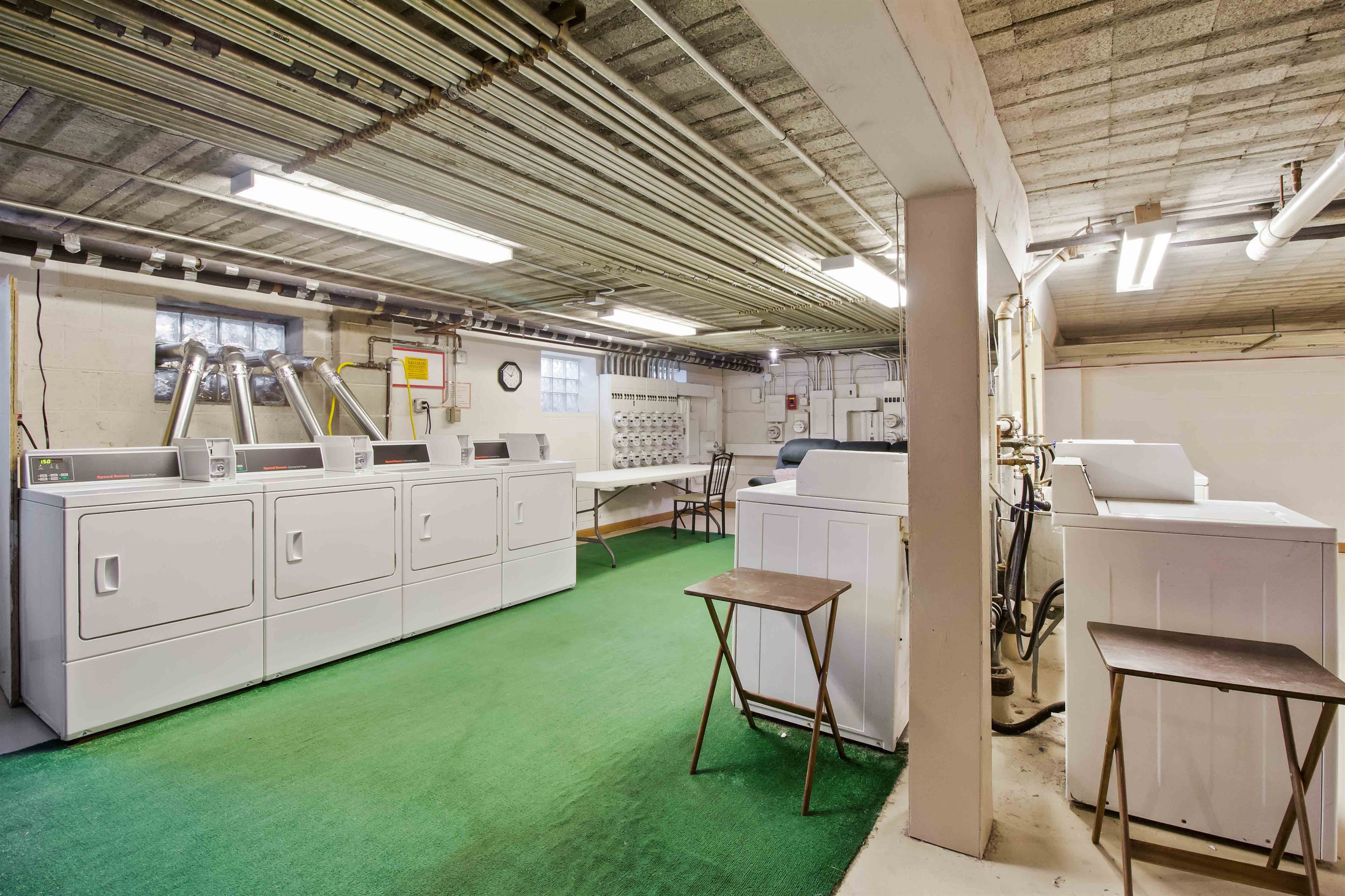 Coin laundry in basement, washers and dryers.